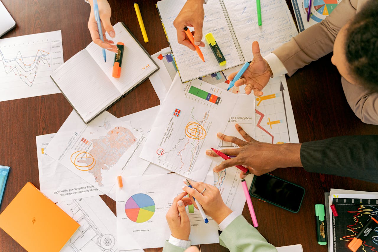 The Art of Drawing Readers In: Your attractive post title goes here Business professionals collaborating over charts and data in a conference room.